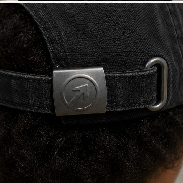 Detail — brushed-metal OneFaze buckle on the Charcoal Black Heritage Washed Cap