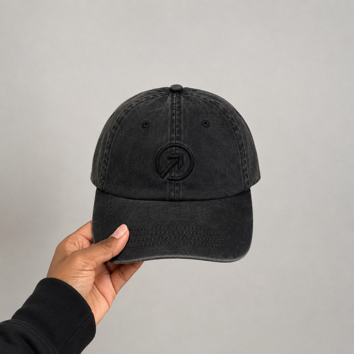 Held — Charcoal Black Heritage Washed Cap shown in hand