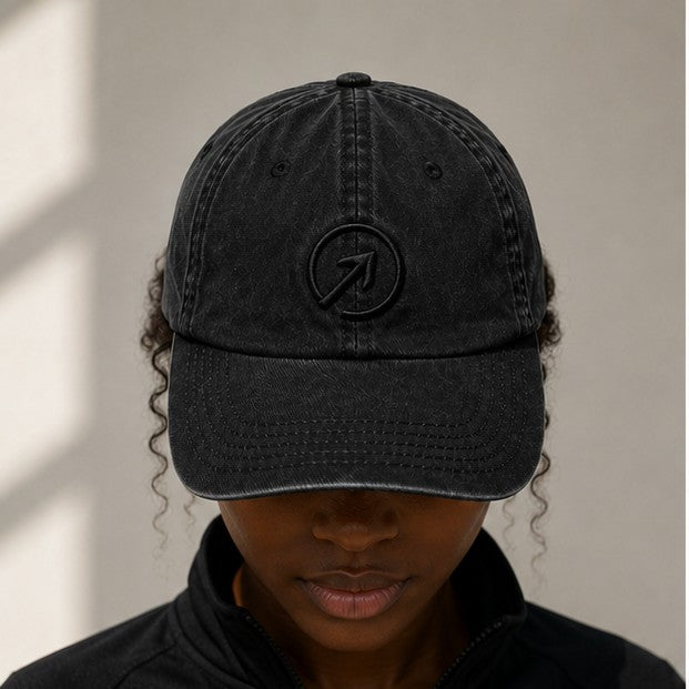 Worn front — Charcoal Black Heritage Washed Cap in natural daylight